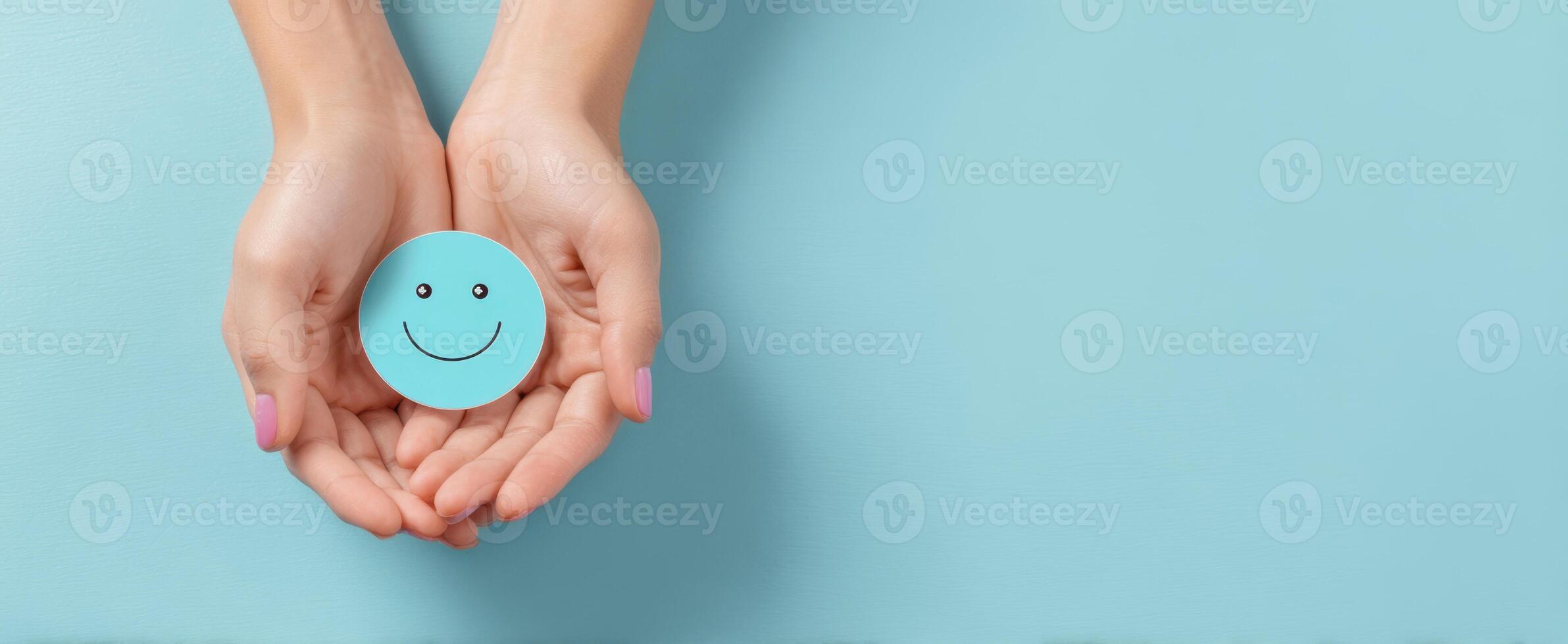 The hands holding a smiling face symbolizing happiness and positivity. photo