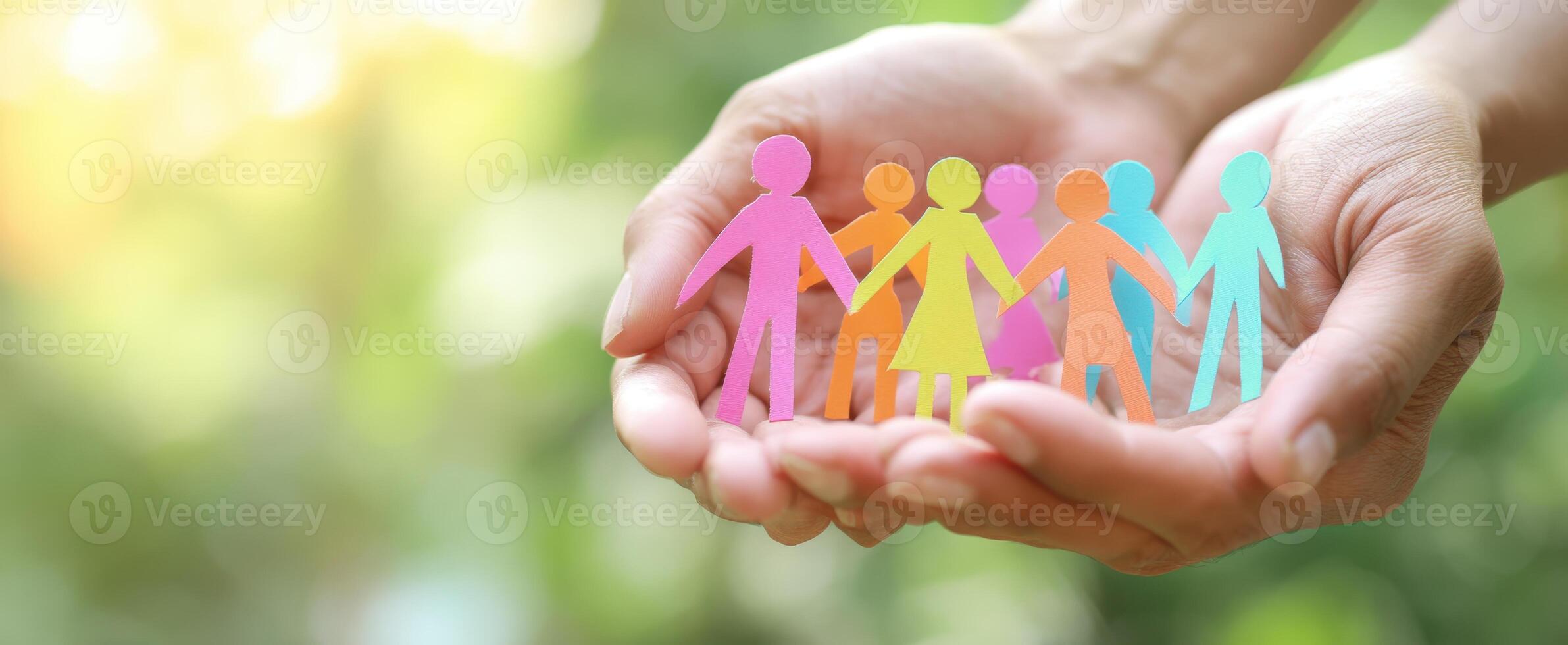 The colorful paper figures representing unity and community in hands. photo