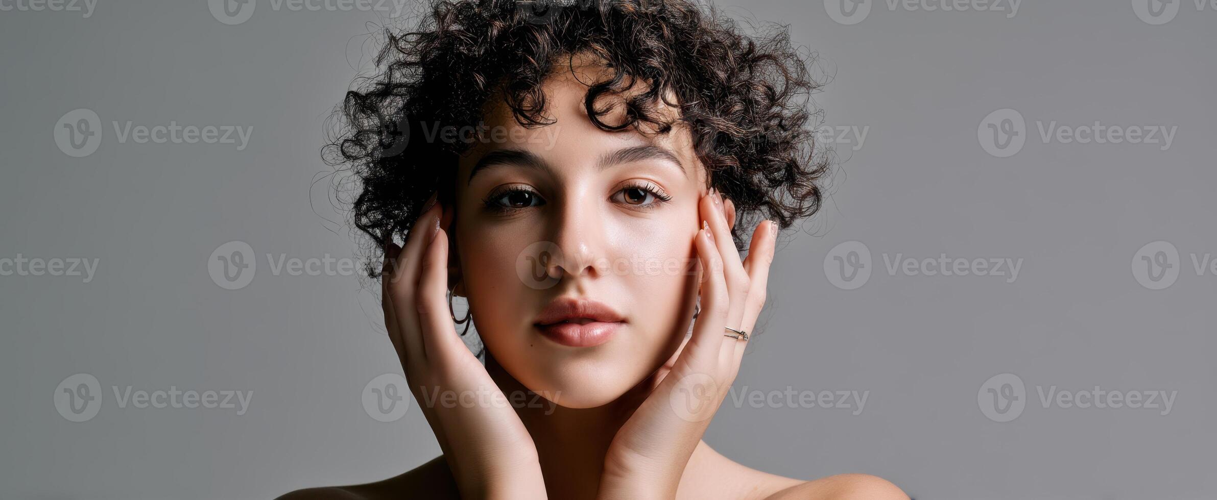 The captivating beauty of a woman with curly hair and an elegant expression. photo