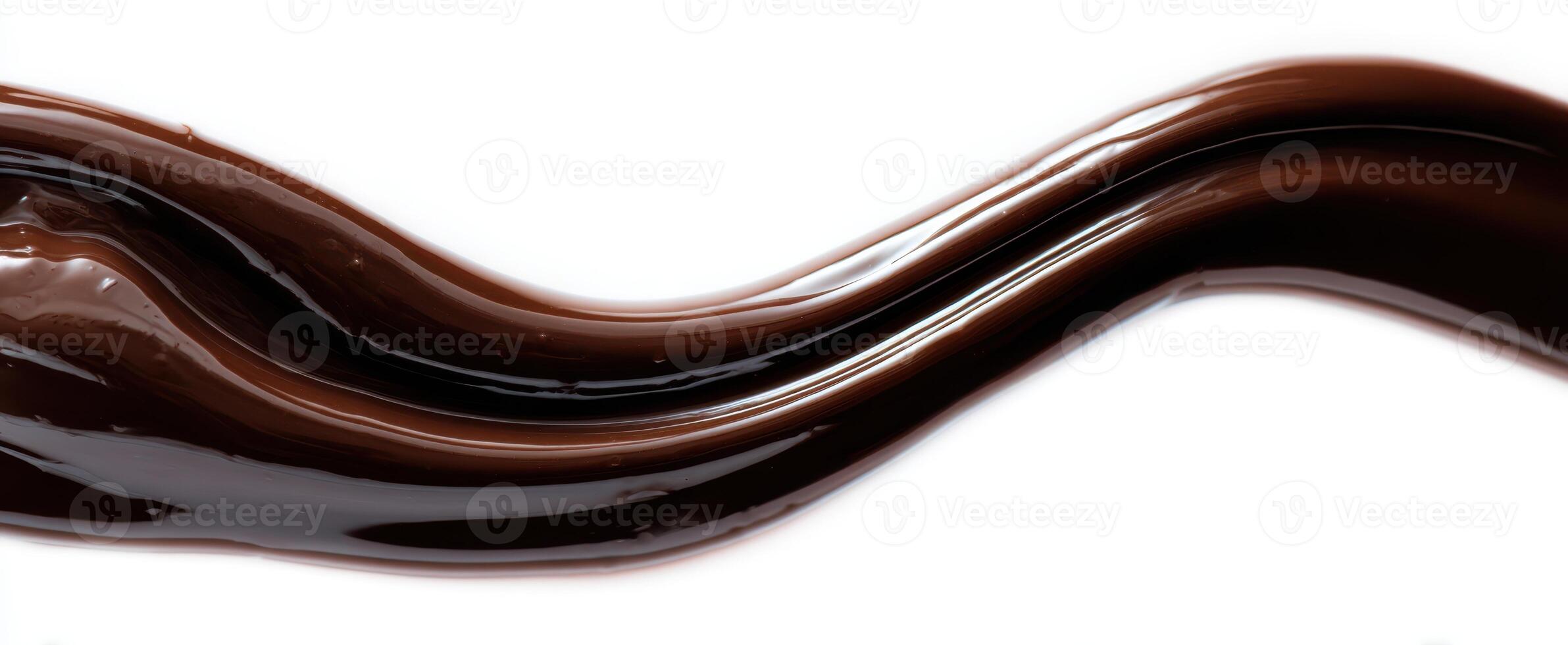 The smooth wave of rich, dark chocolate sauce on a white background photo