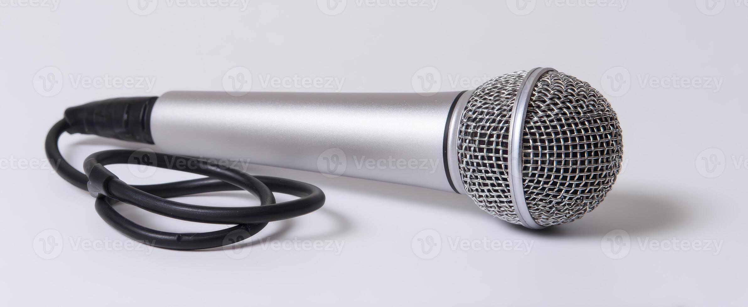 The microphone laying on a white background for audio and music performance. photo