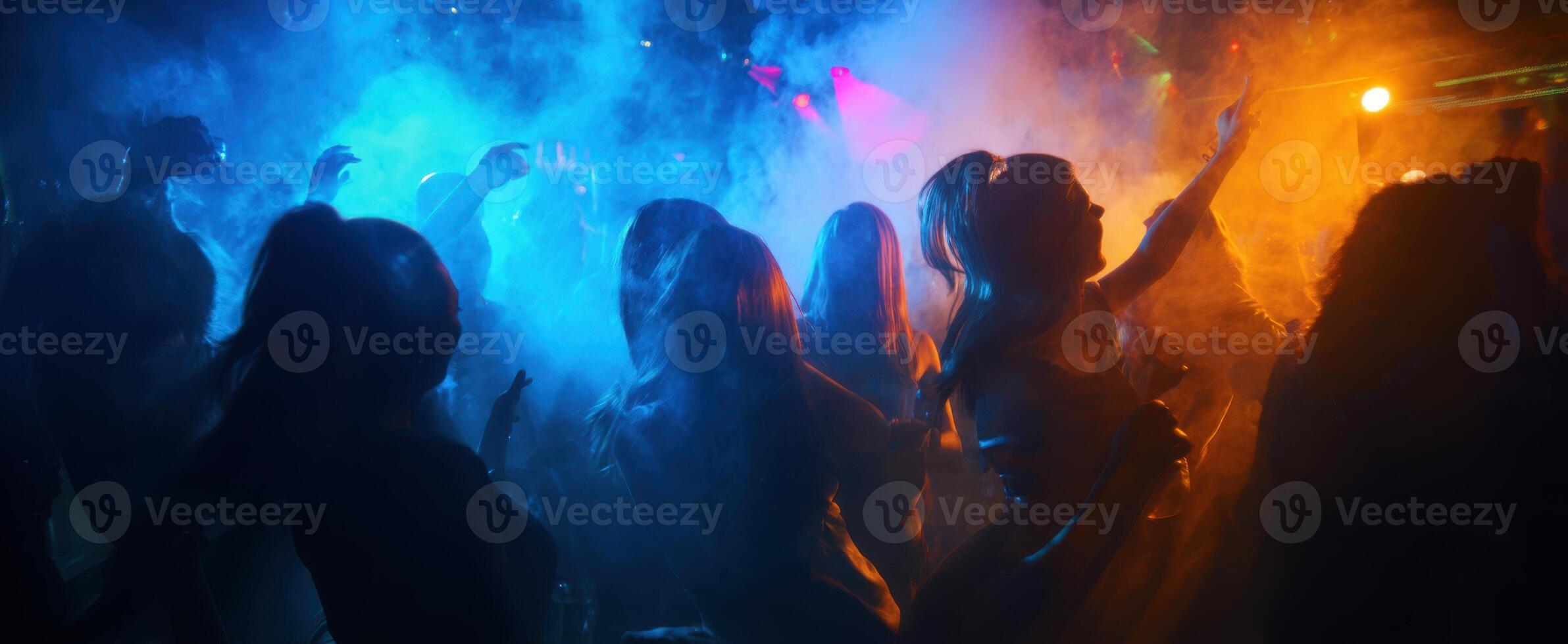 The vibrant energy of a lively club filled with dancing silhouettes. photo
