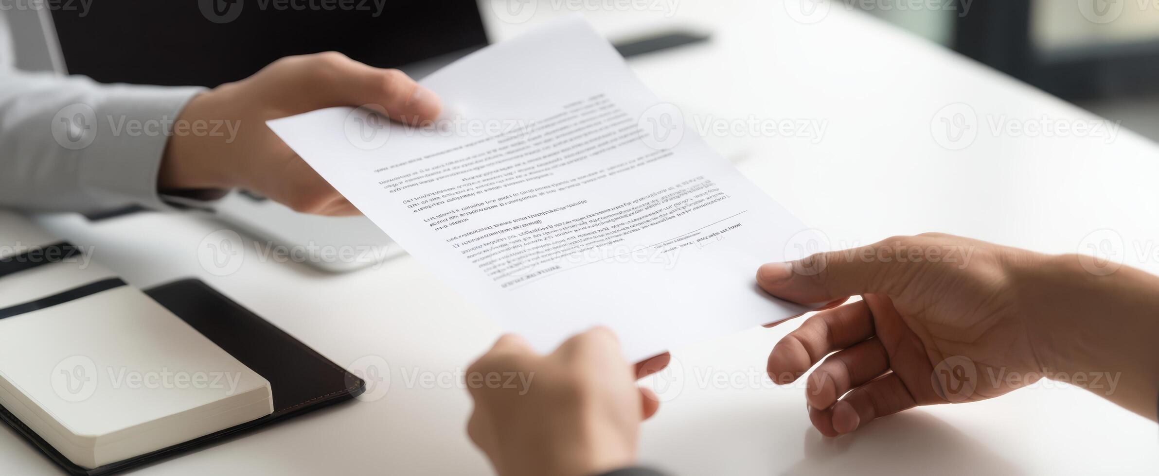 The hands exchanging a document in a professional business meeting setting. photo