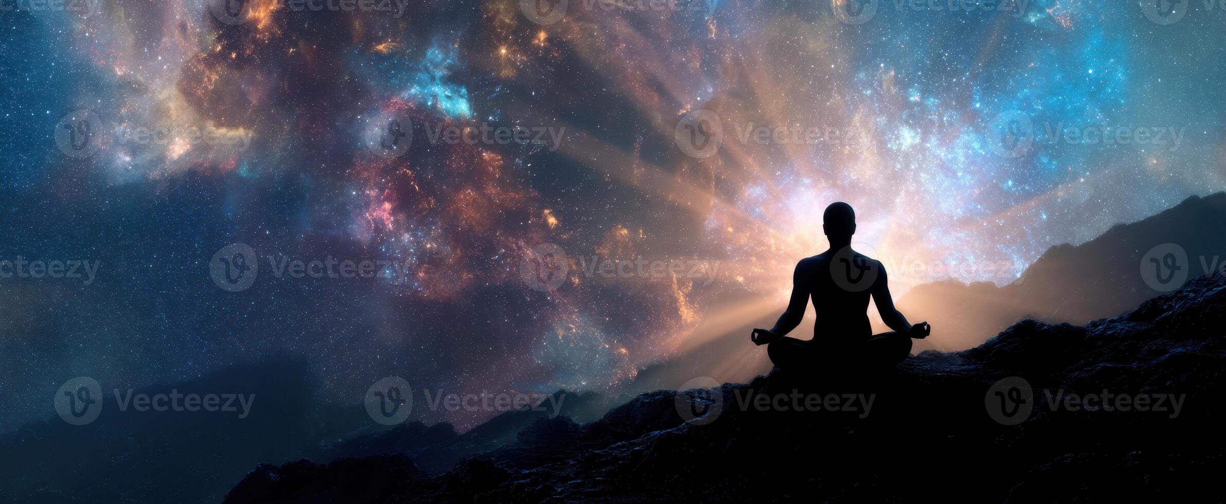 The silhouette of a meditator surrounded by a vibrant cosmic galaxy. photo