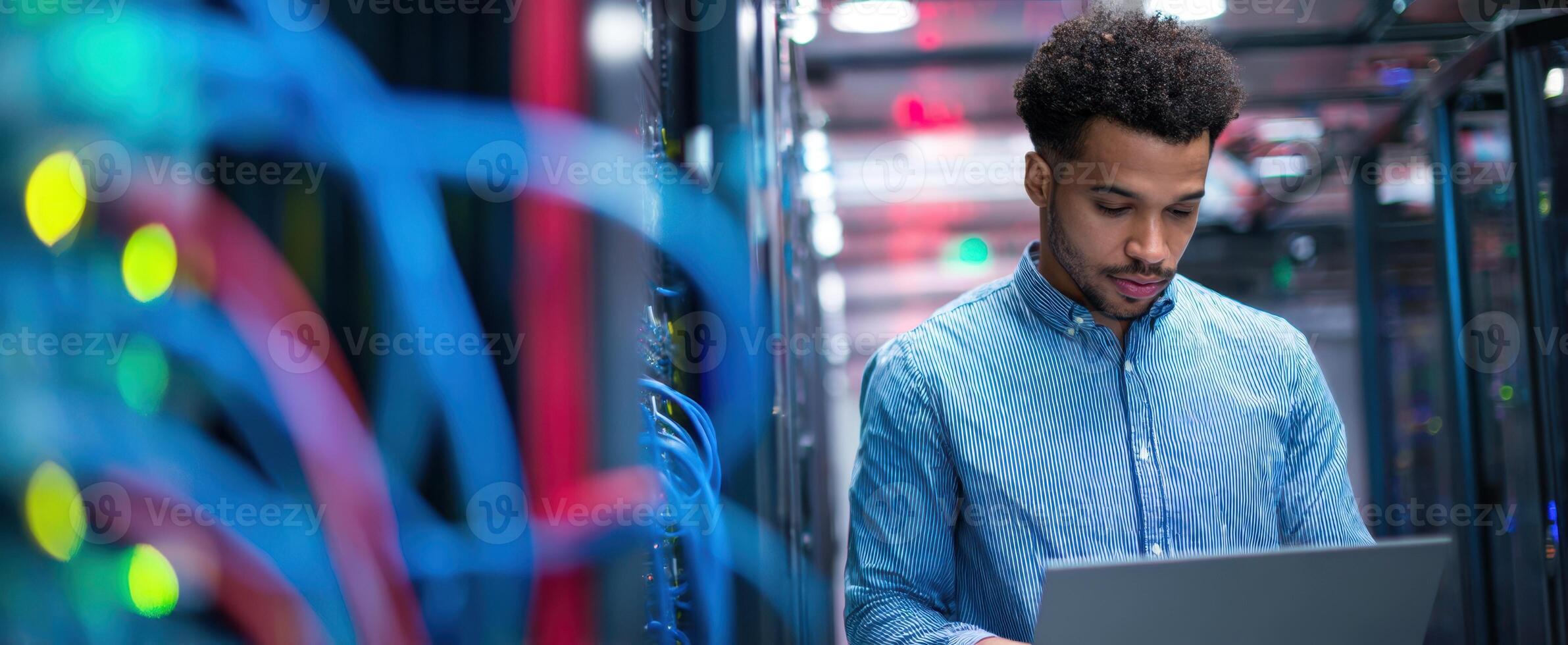 The focused professional examining data in a modern server room. photo