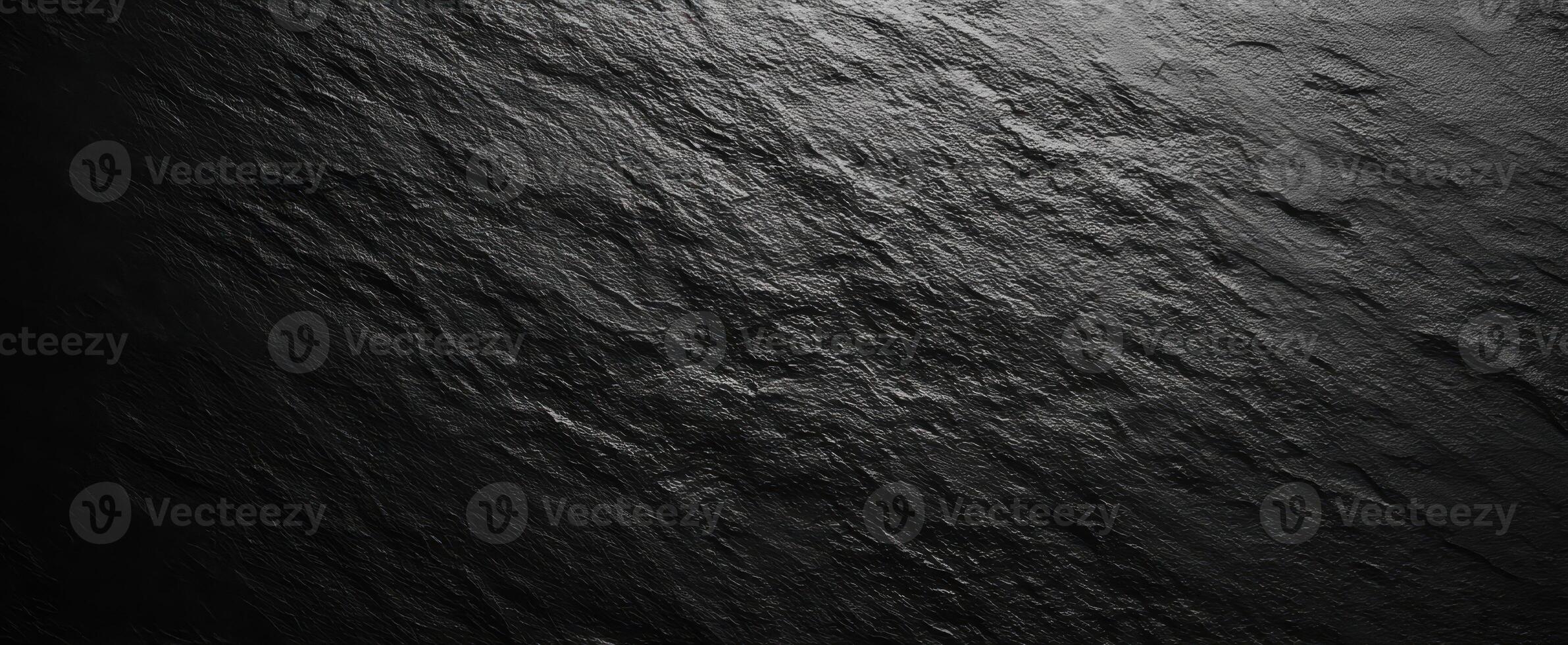 The sleek dark slate surface with beautiful texture and shadows. photo