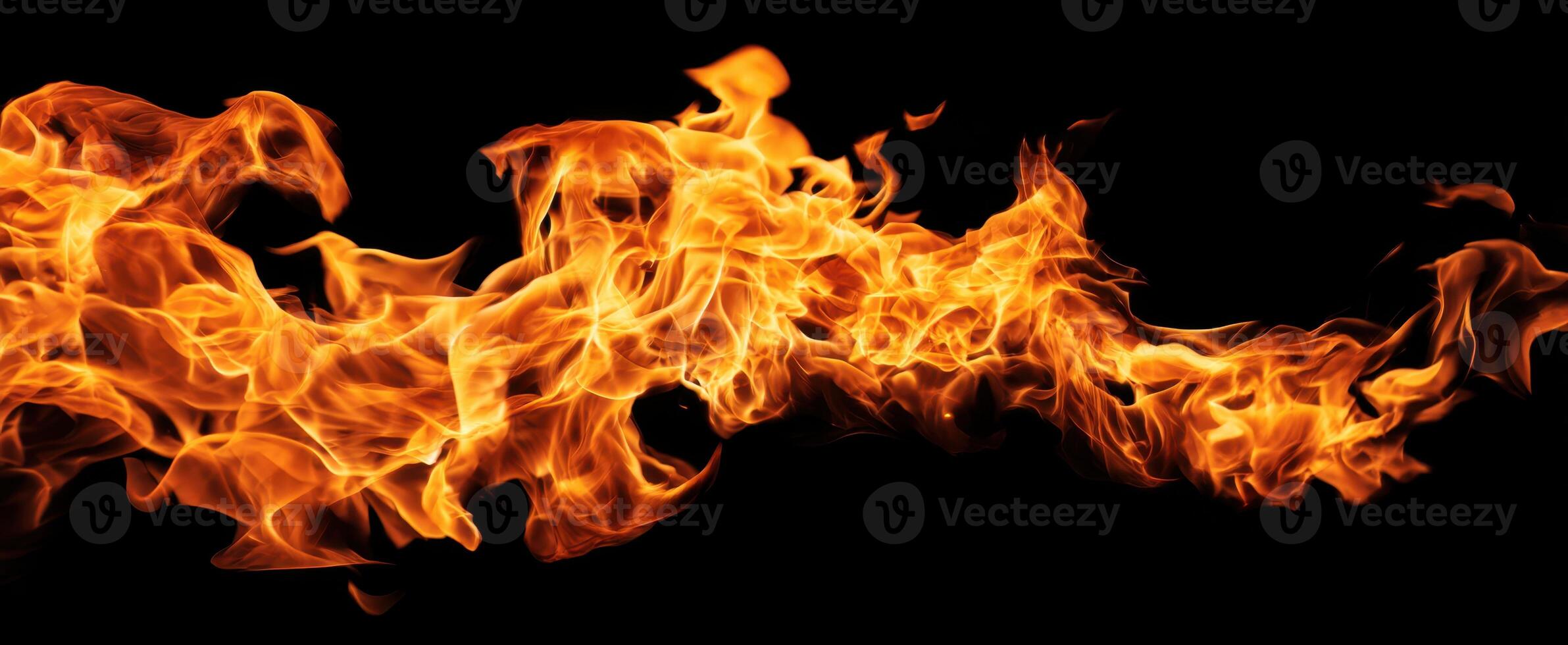 The vibrant flames dancing in darkness create a mesmerizing, fiery spectacle. photo