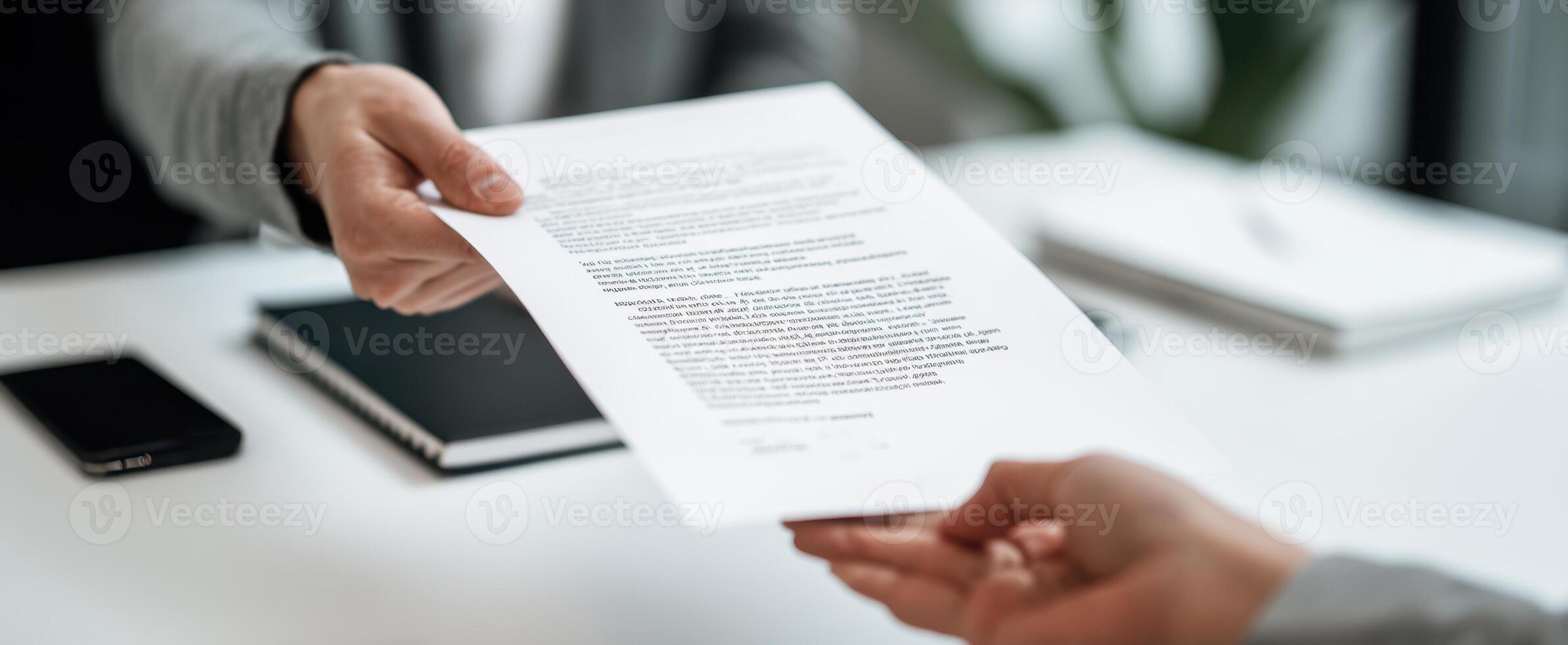 The person handing over an important document in a professional office setting. photo
