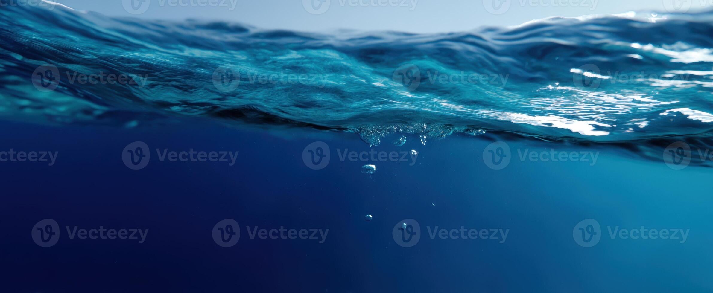 The tranquil underwater view showcasing the beauty of ocean waves and bubbles. photo