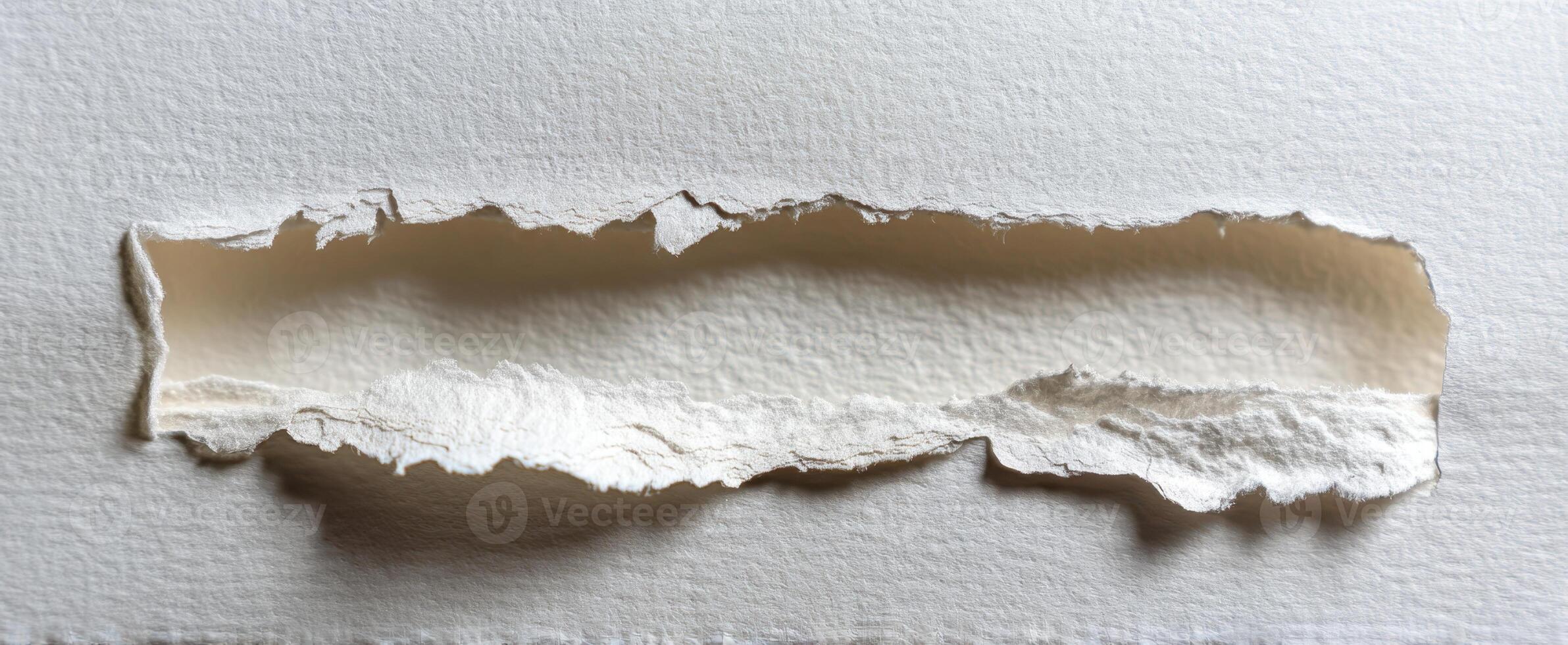 The torn paper revealing a soft texture underneath in an artistic composition. photo