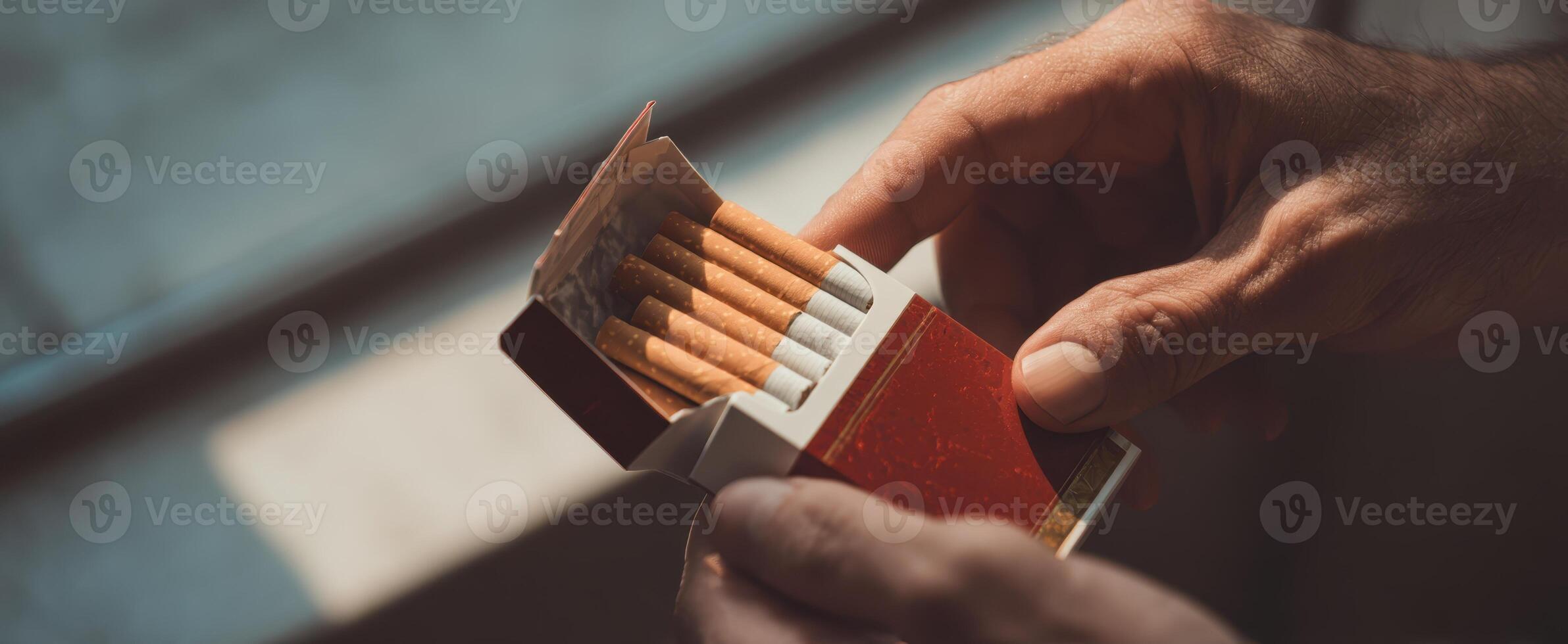 The Hands Holding an Open Cigarette Box in Soft Natural Light photo
