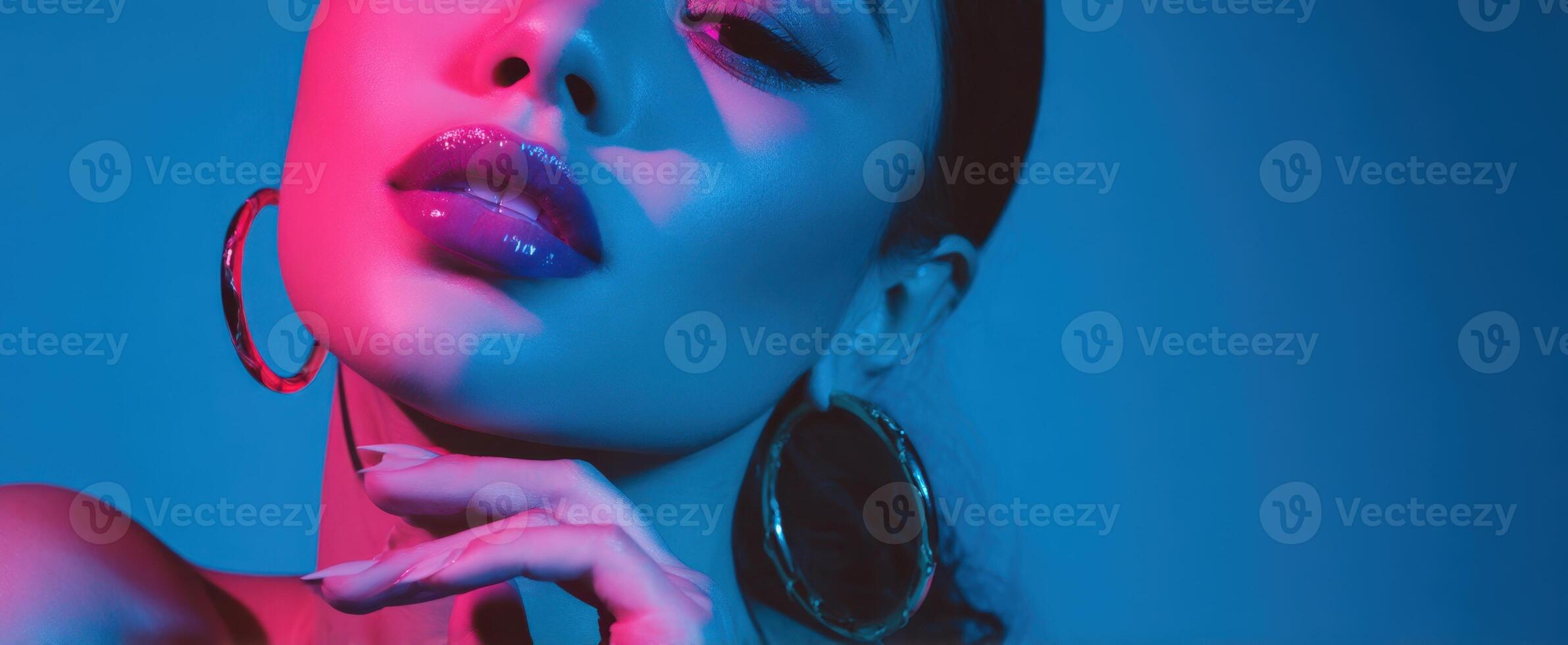 The striking portrait of a glamorous model with vibrant lighting and bold makeup. photo