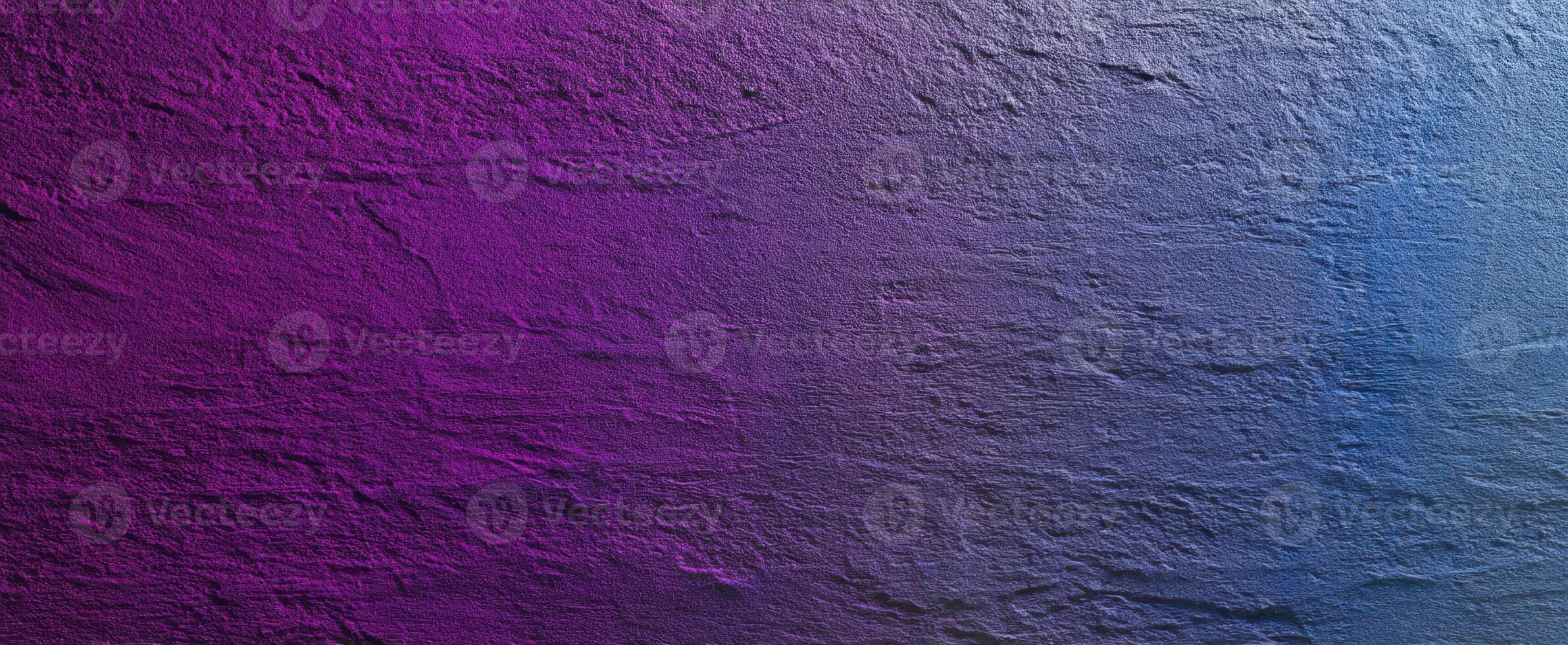 The gradient texture of a purple and blue wall surface. photo