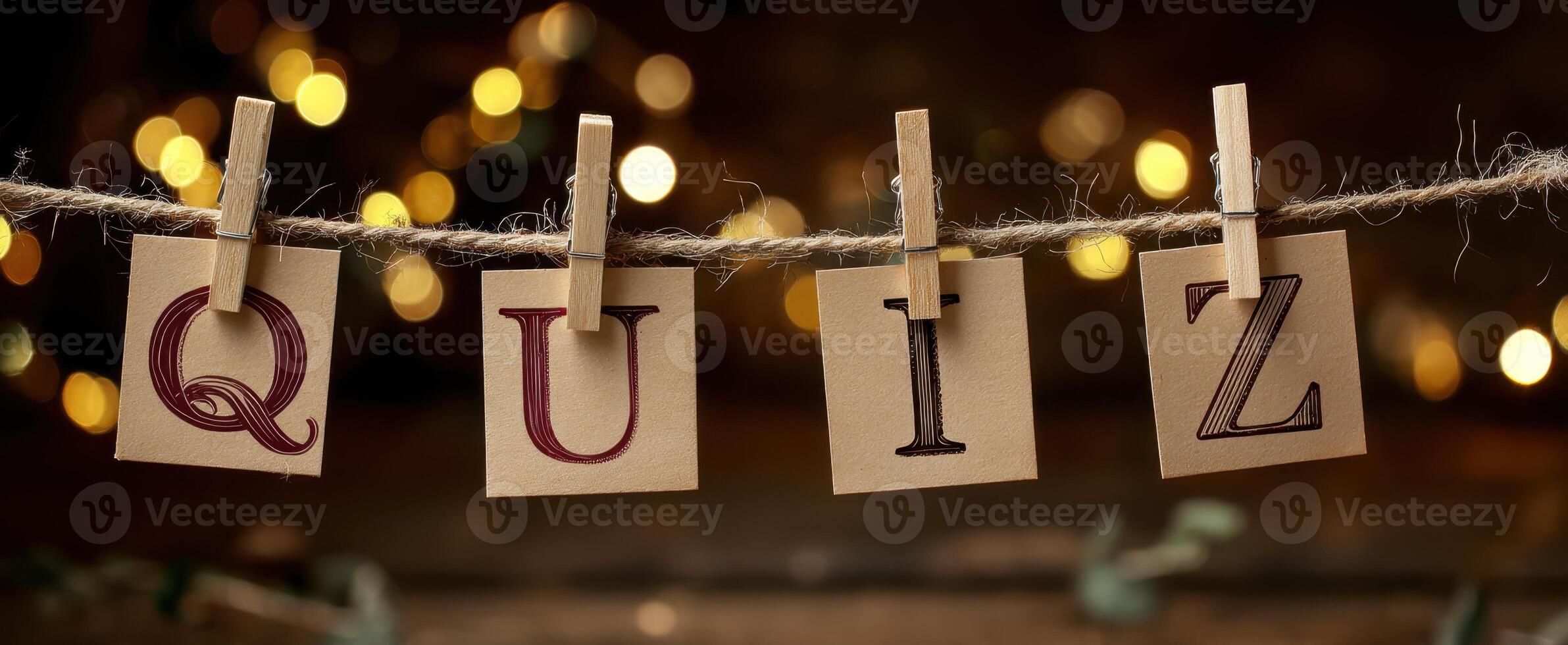 The Quiz Letters Displayed with Warm Bokeh Background and Clothespins photo