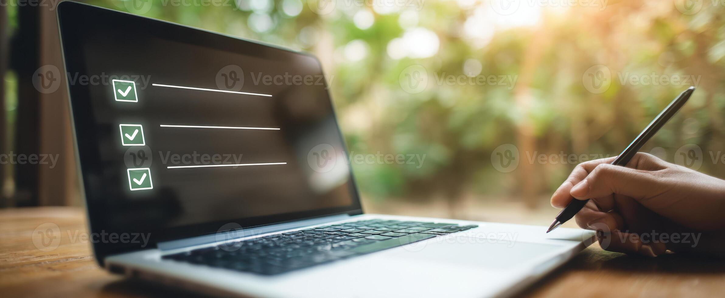 The laptop displaying a checklist in a serene outdoor workspace. photo