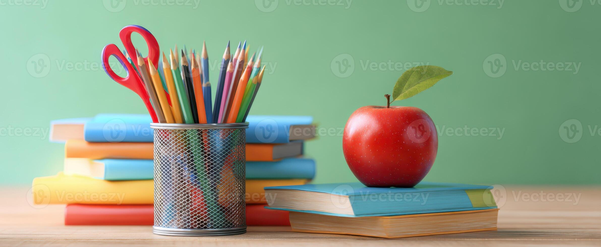 The vibrant classroom setup with colorful pencils, books, and a fresh apple. photo