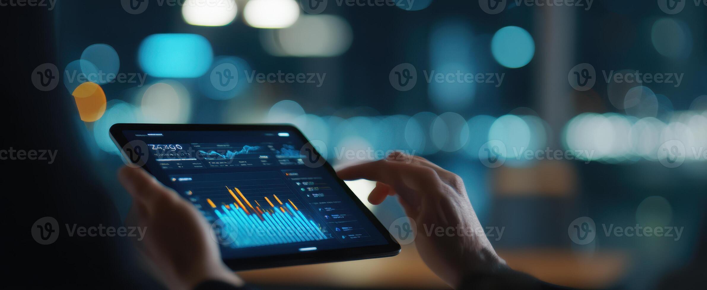 The tablet displaying financial data in a modern, illuminated workspace setting. photo