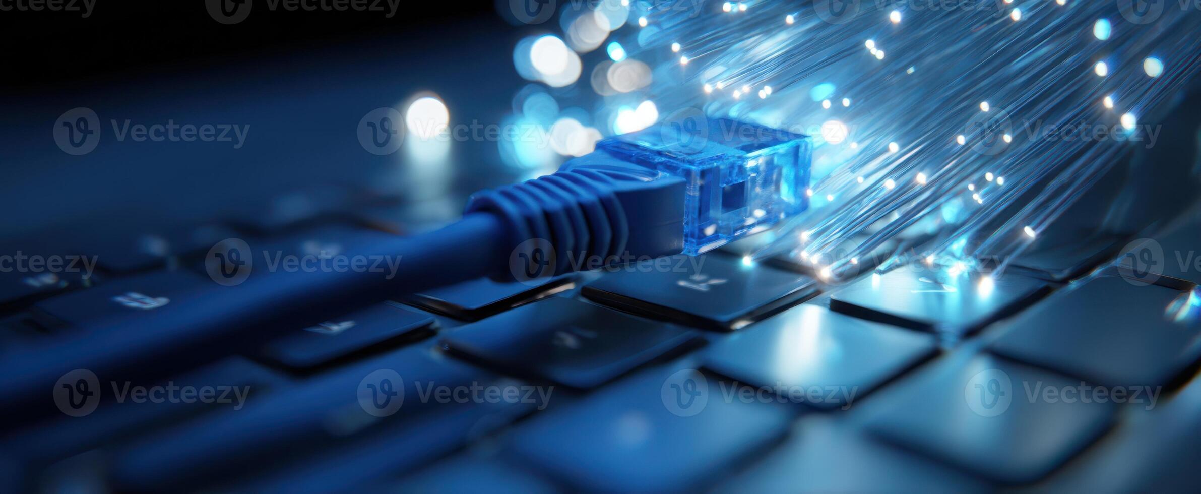 The glowing fiber optic cable connected to a modern computer keyboard. photo