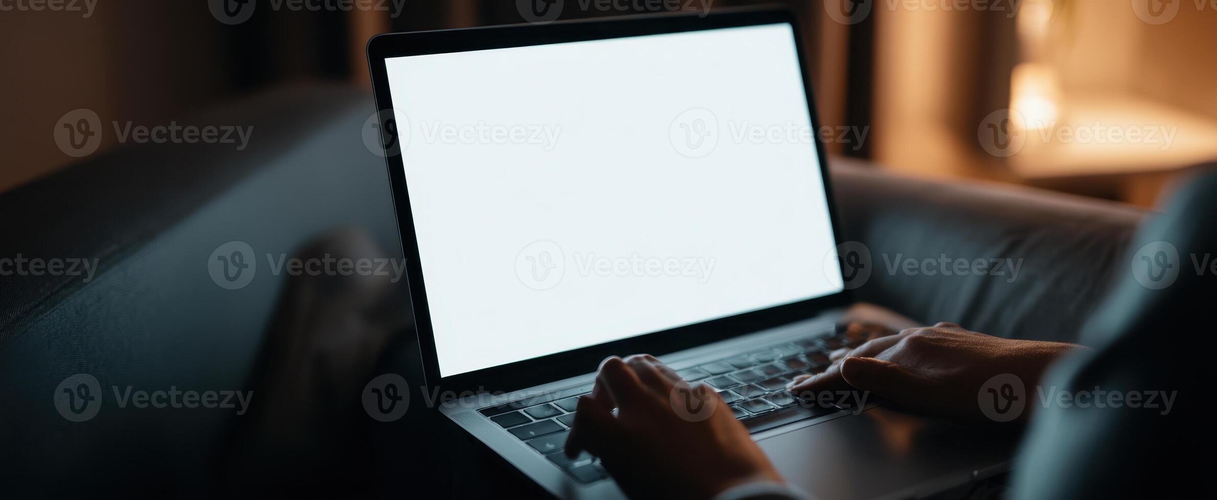 The Laptop on a Couch During an Evening Work Session. photo
