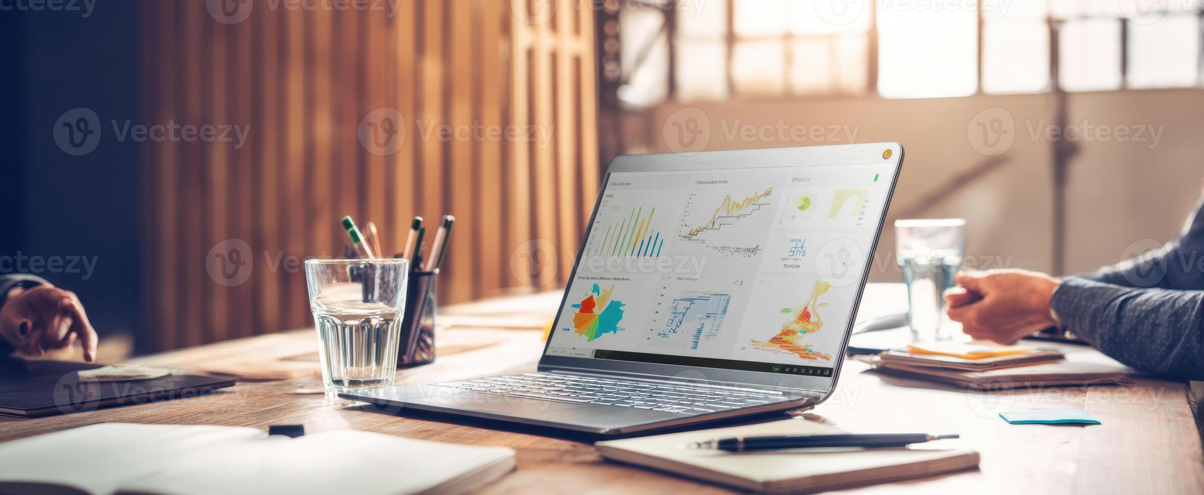 The laptop displaying data analysis in a modern collaborative workspace. photo