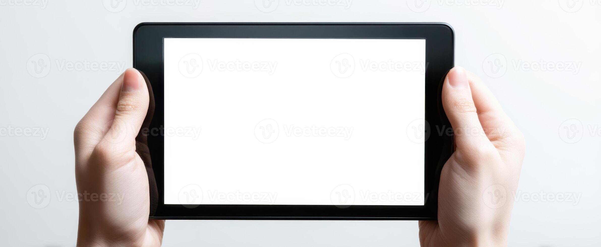 The tablet held in hands with a blank screen for design purposes. photo