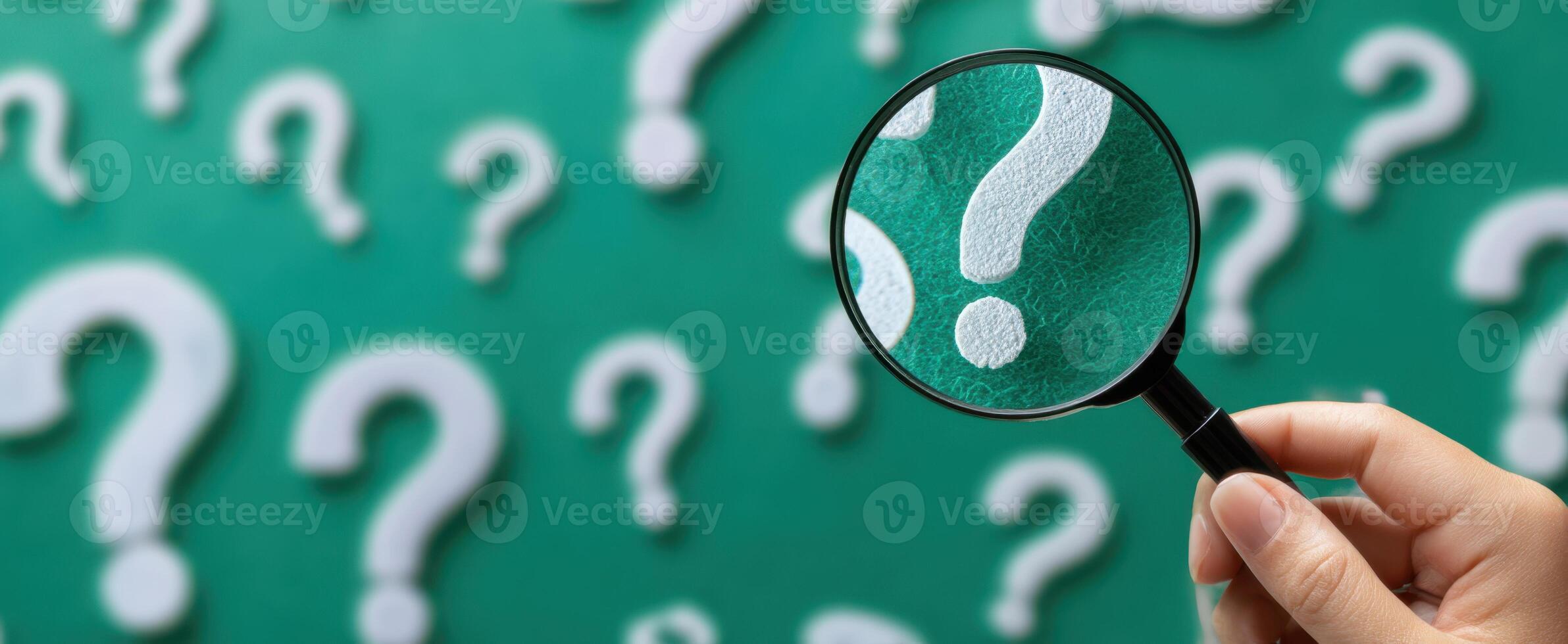 The Magnifying Glass Highlighting Questions on a Green Background photo