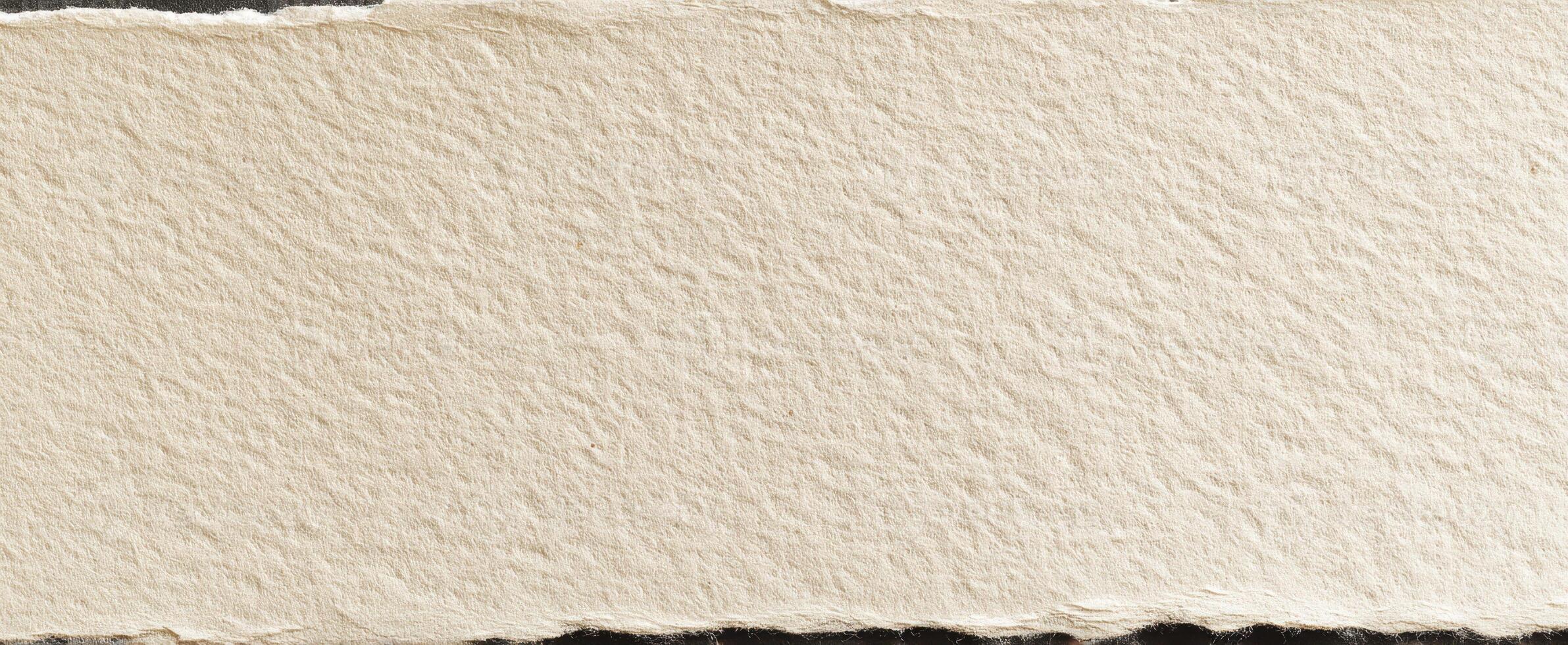 The textured surface of handmade paper with a torn edge for crafts. photo