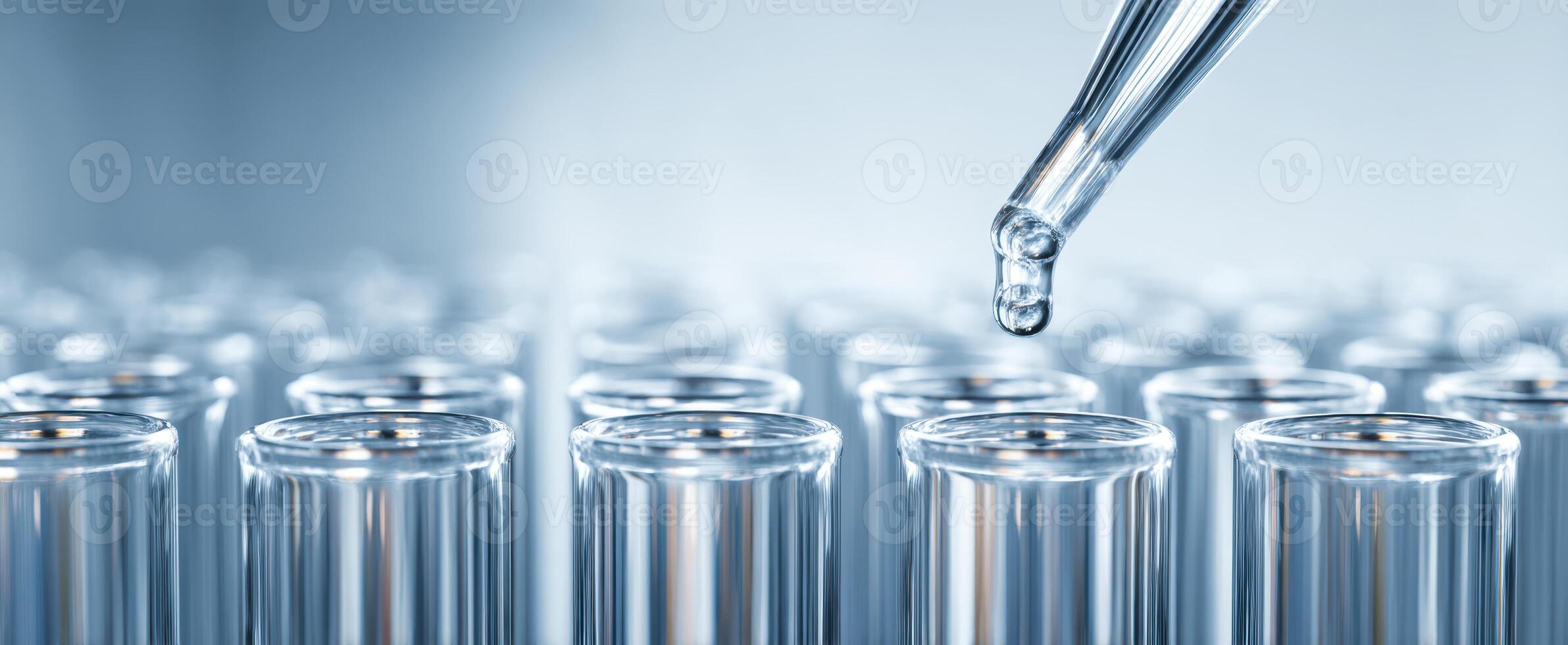 The precise moment of a pipette dropping liquid into laboratory test tubes. photo