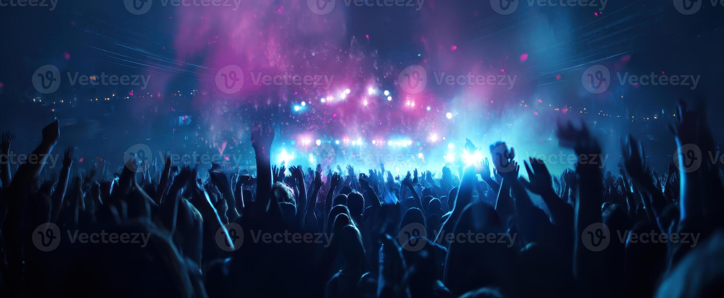 The vibrant atmosphere of a lively concert crowd enjoying the music. photo