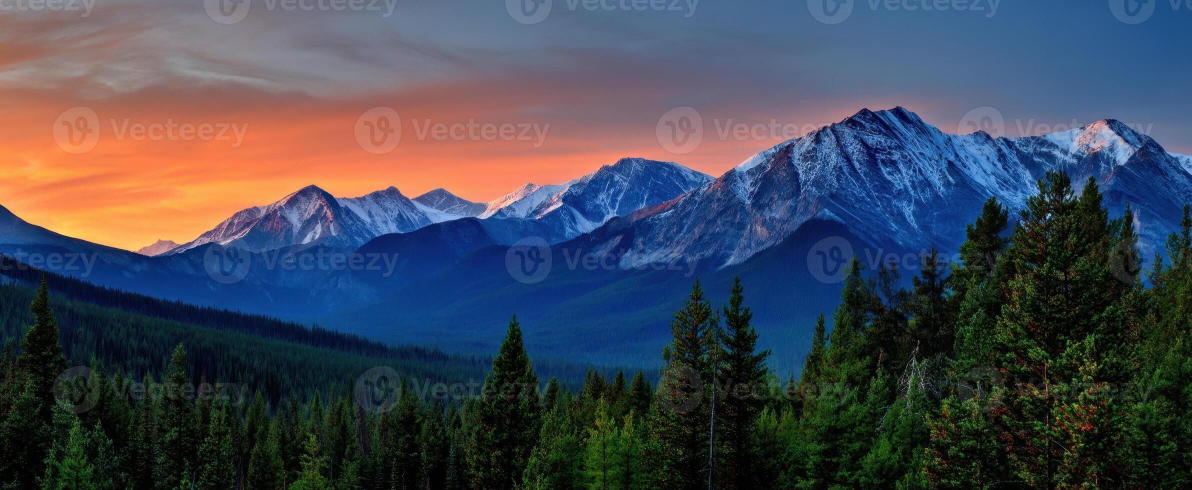 The majestic mountains under a vibrant sunset sky. photo