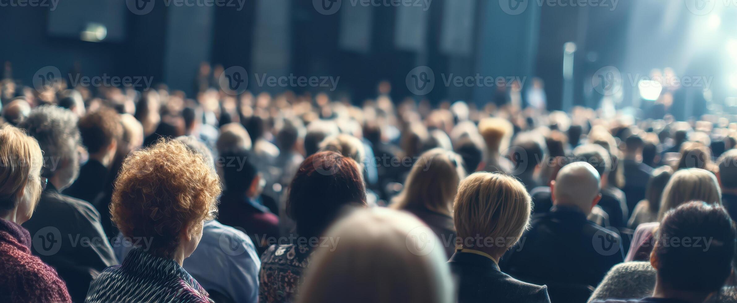 The engaged audience attending a captivating event in a large venue. photo