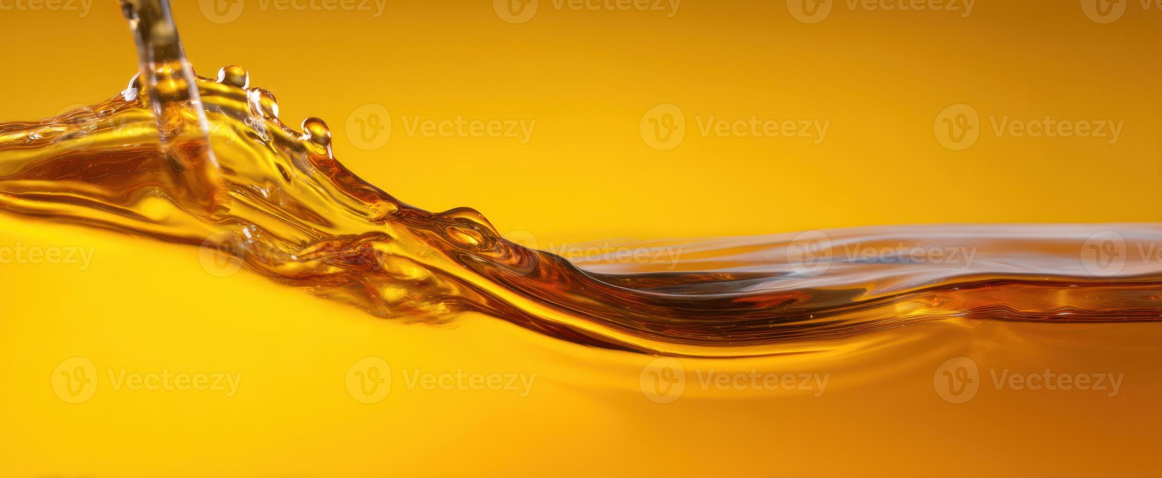 The beautiful golden wave of liquid captures light and movement exquisitely. photo