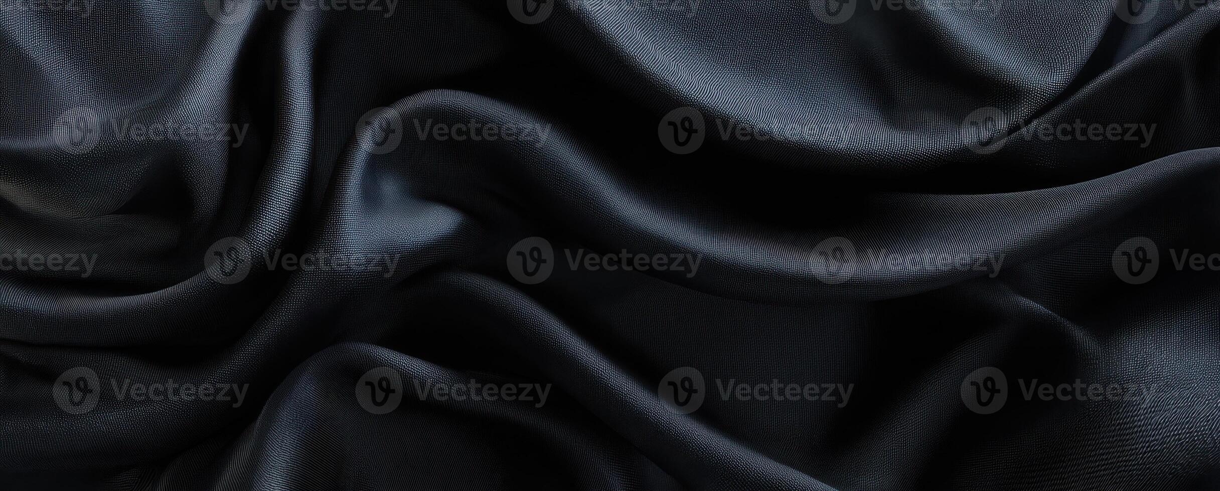 The smooth black silk fabric creating elegant folds and captivating texture. photo