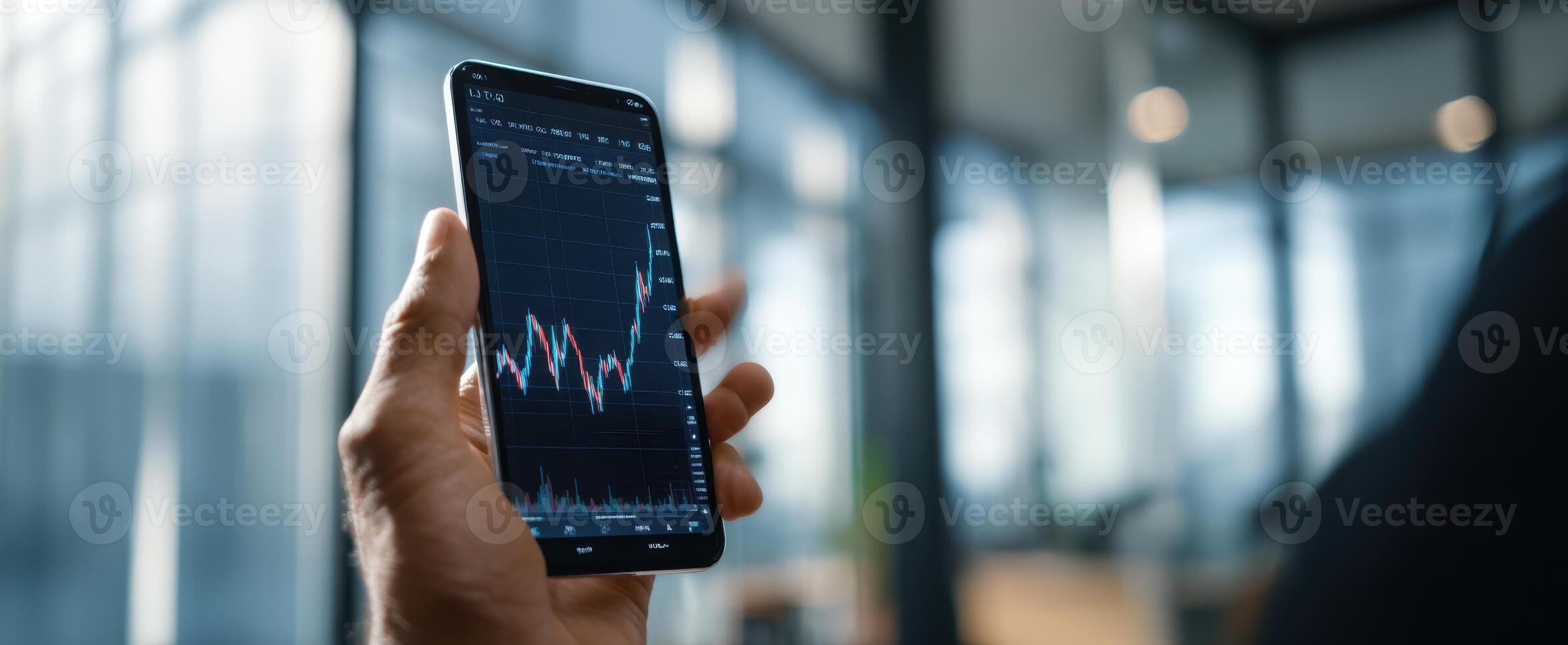 The smartphone displaying stock market trends in a modern office setting. photo