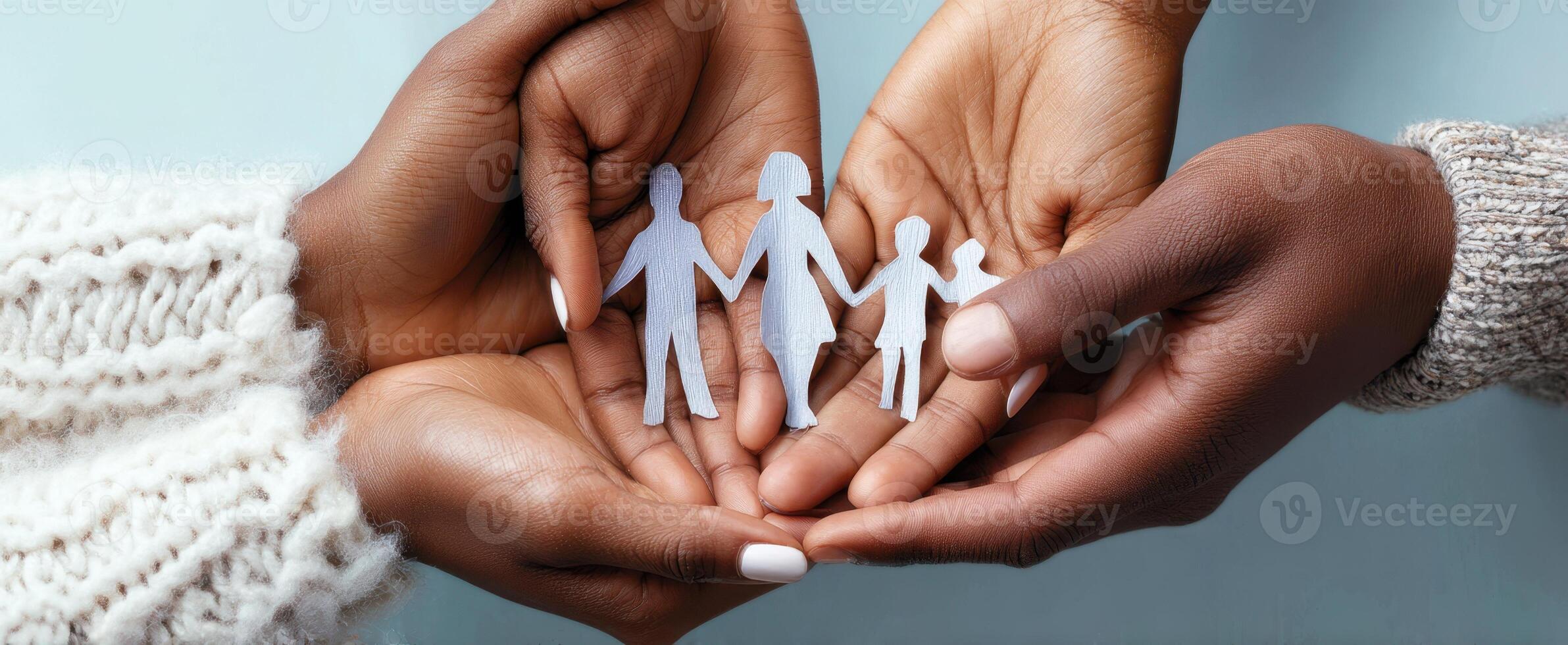 The Family Paper Figures Held in Gentle Hands Representing Unity and Love. photo