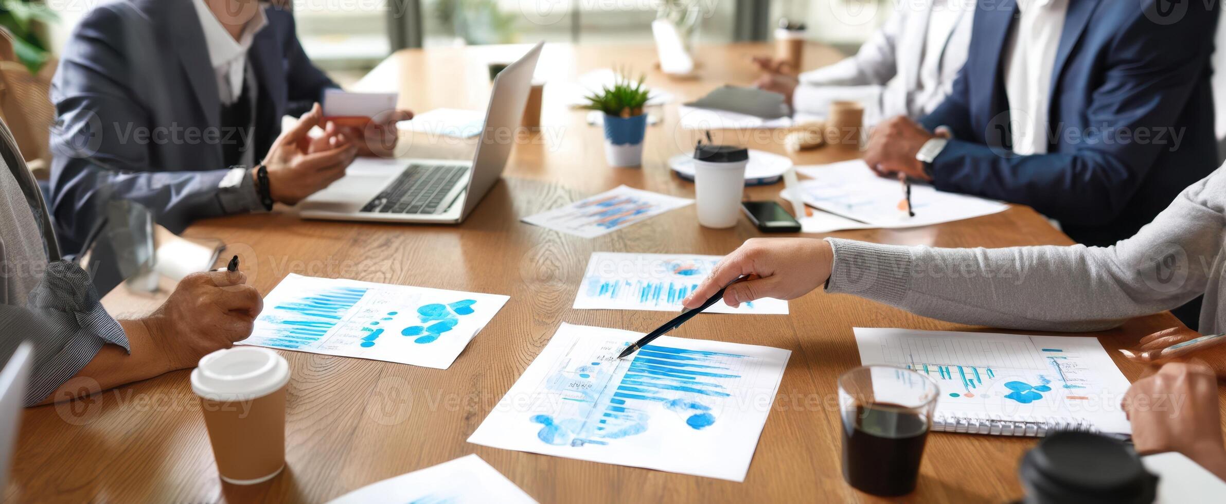 The business team in a strategic meeting analyzing financial charts and data. photo