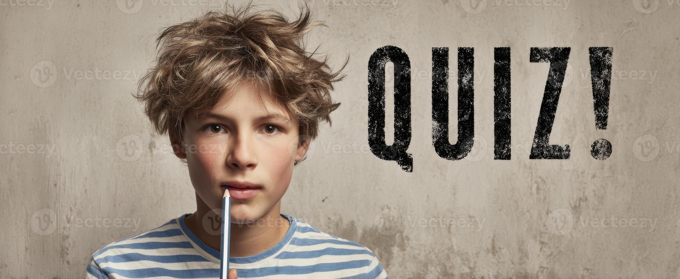 The boy pondering over a quiz while holding a pencil thoughtfully photo