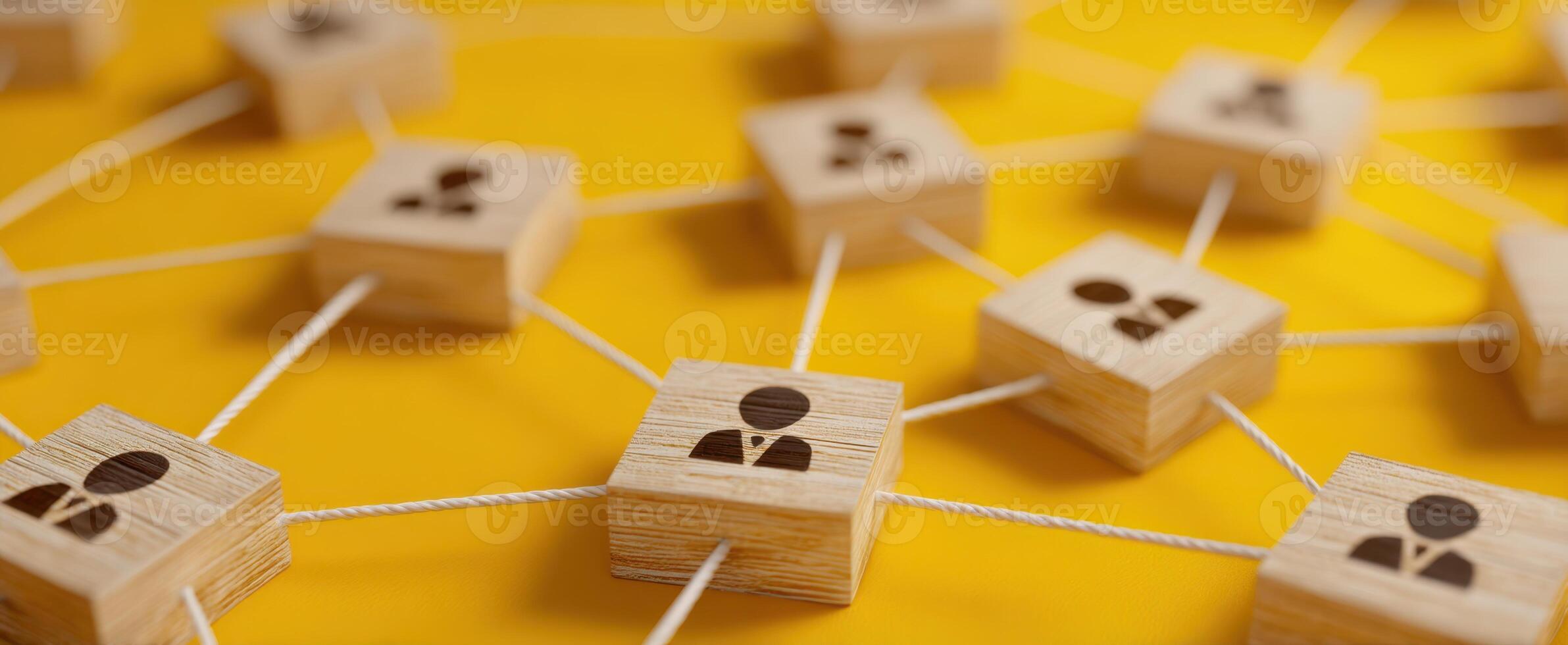 The network of interconnected people represented by wooden blocks and strings. photo