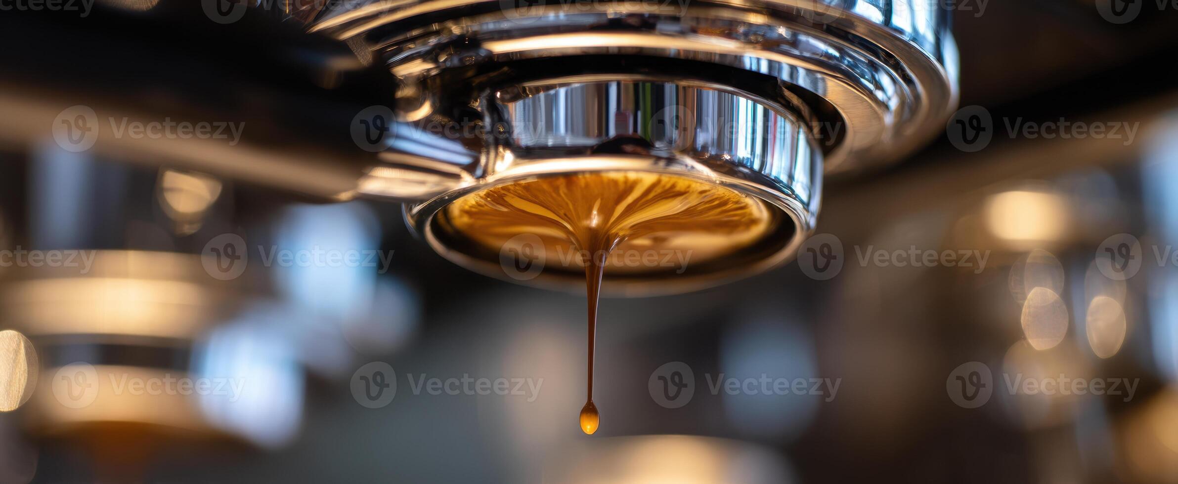 A coffee machine is pouring coffee into a cup photo