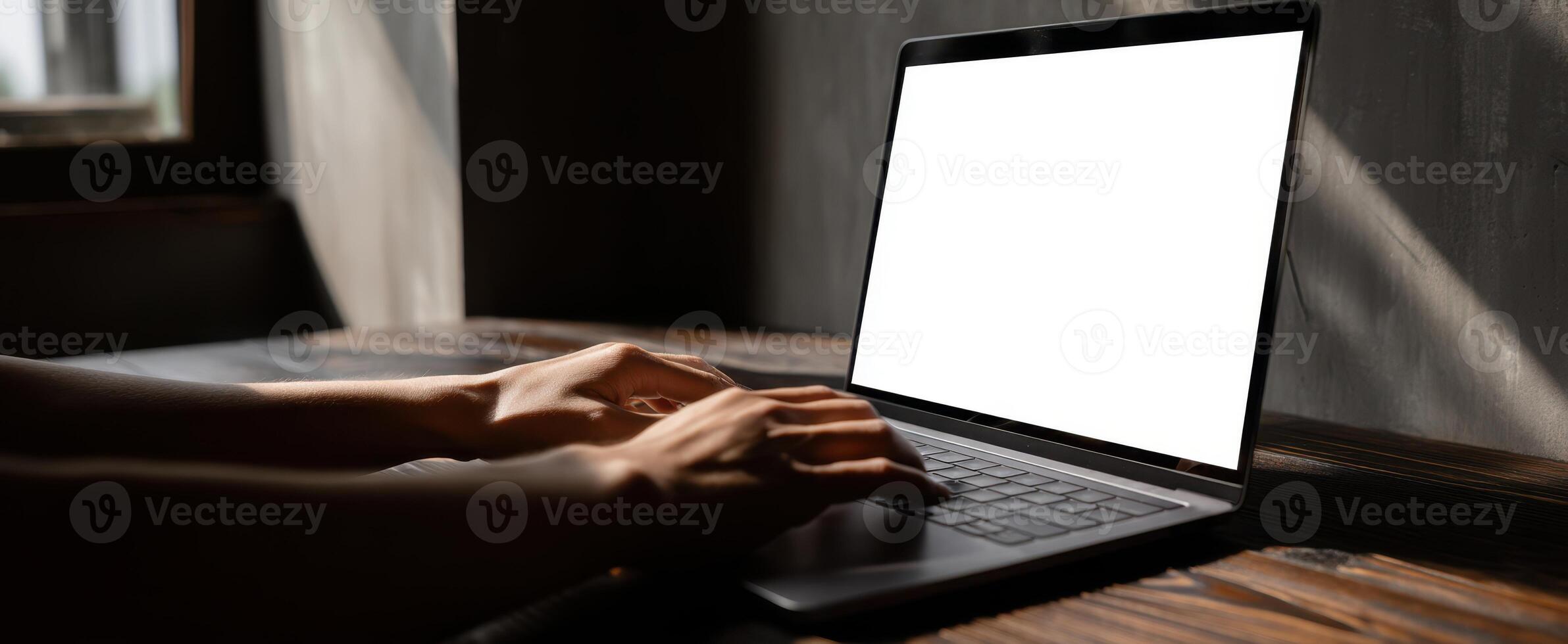 The laptop with hands typing in an ambient workspace setting. photo