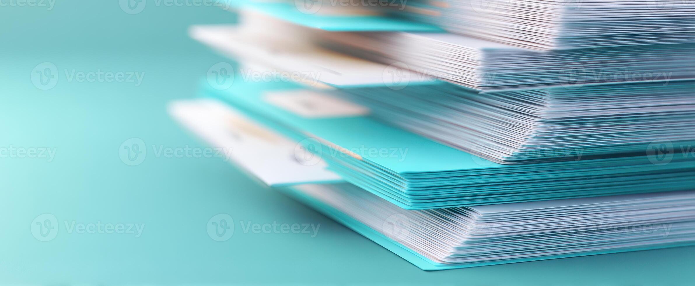 The vibrant stack of organized documents on a turquoise background. photo
