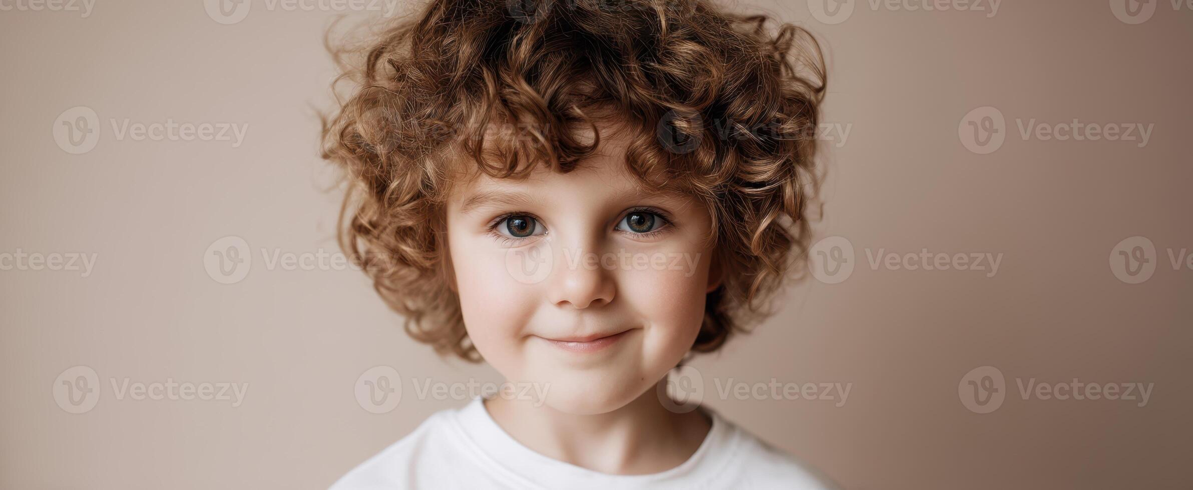 The adorable child with curly hair smiling in a warm, inviting setting. photo