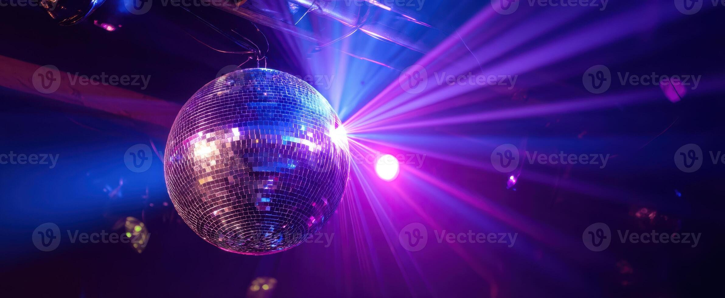 The sparkling disco ball reflecting vibrant lights in a lively party atmosphere. photo