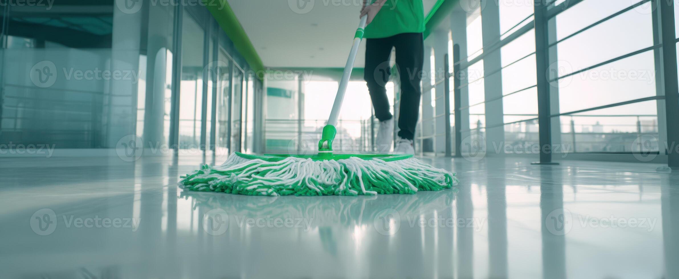 The cleaning professional mopping a shiny floor in a modern office space. photo