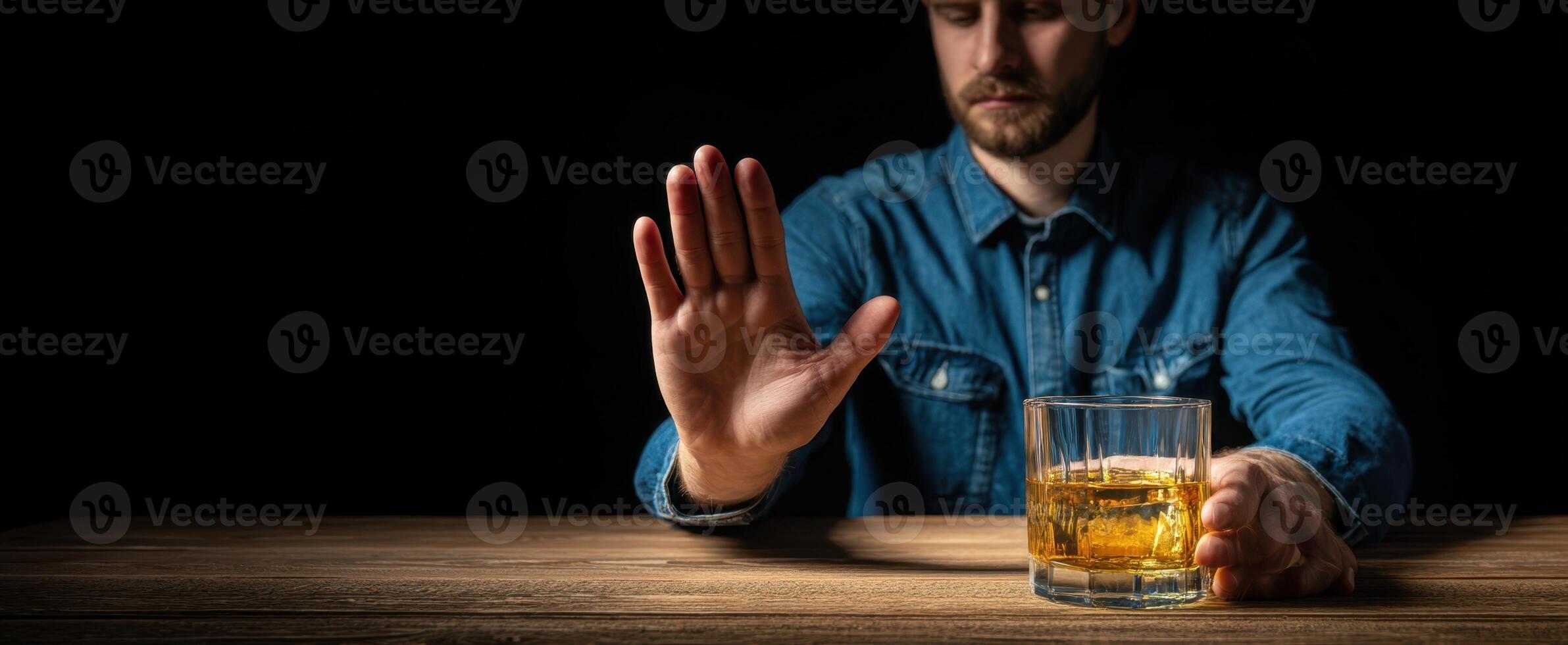 The man refusing to drink whiskey, showcasing an internal conflict. photo