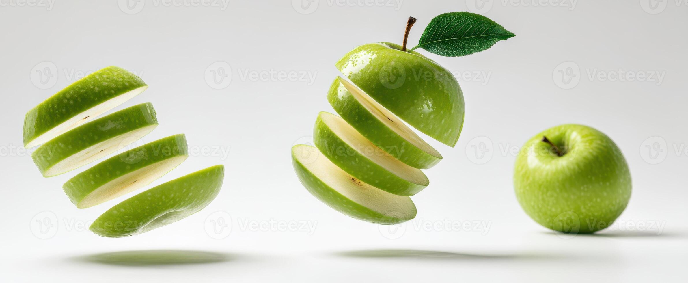 The Green Apple Sliced into Floating Segments Against a White Background photo