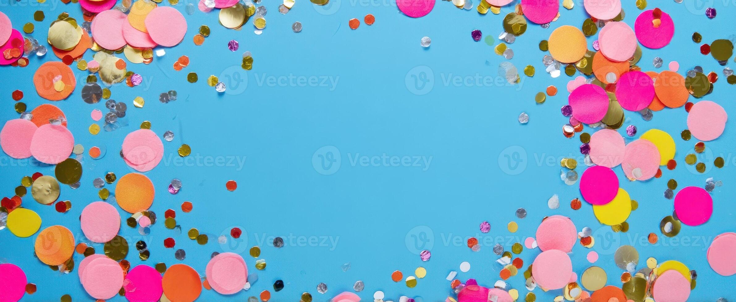 The vibrant confetti arrangement on a bright blue background for festive occasions. photo