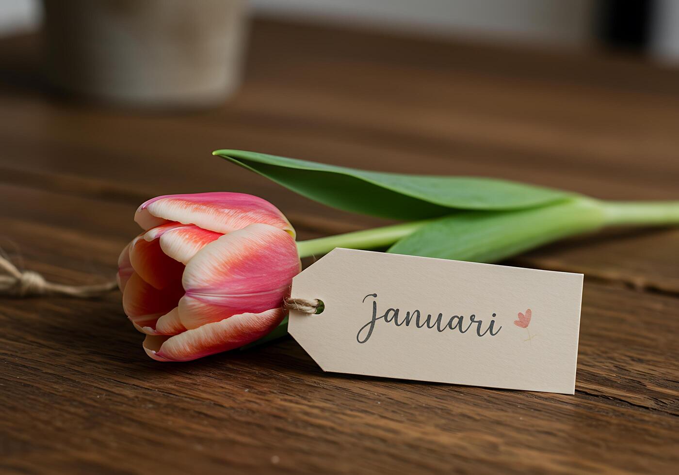 Tulip with January Tag on Wooden Table photo