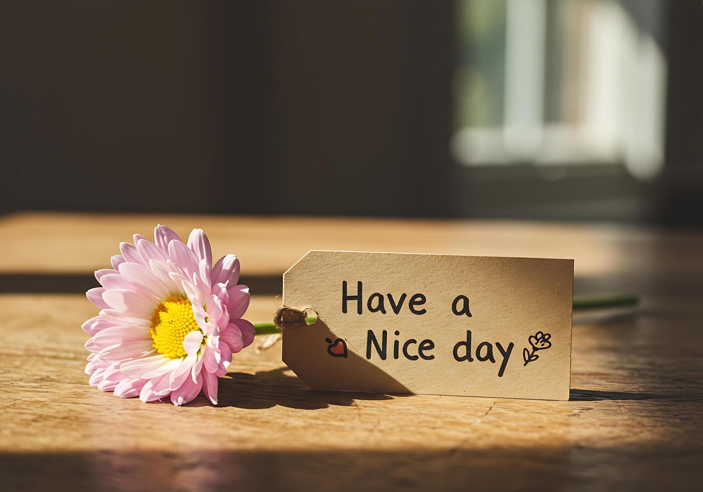 Pink Flower with Message Tag on Wooden Table photo