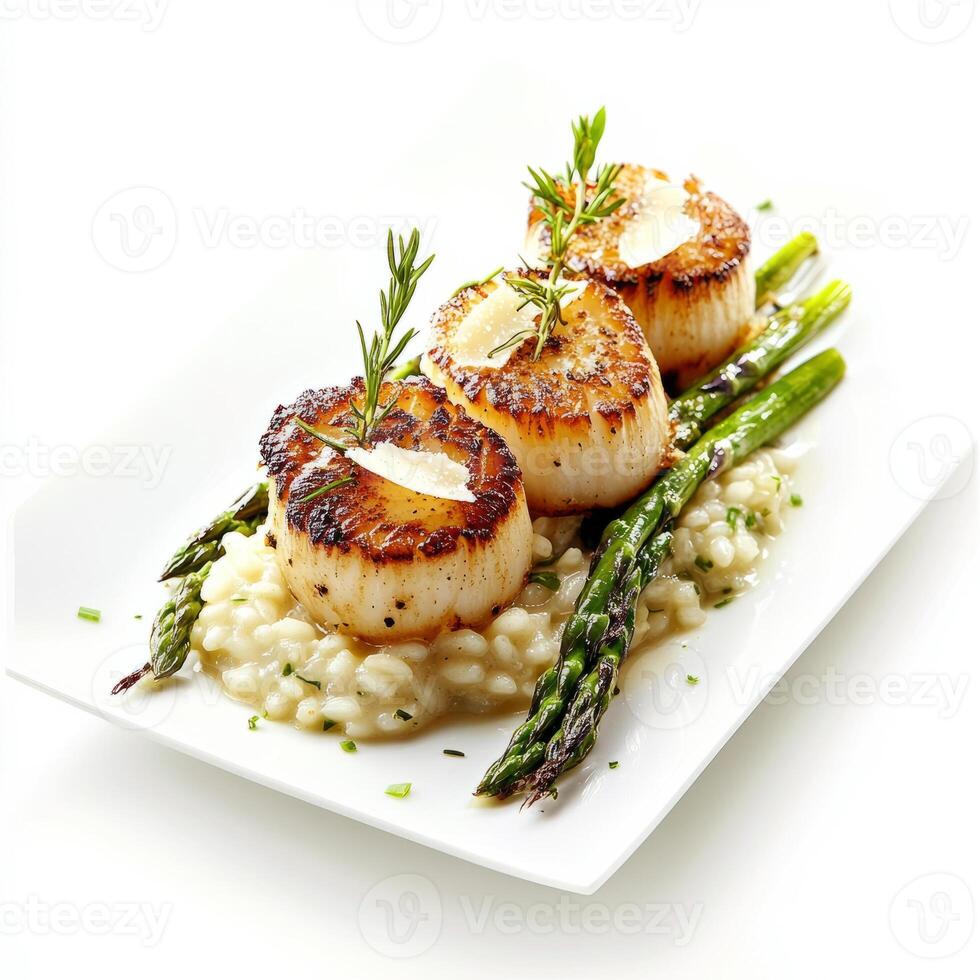 An artistic arrangement of a plate of seared scallops, served on a bed of creamy risotto with photo